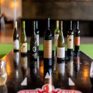 Strike a delicious pose! Wine bottles take on a playful twist, standing tall like bowling pins ready to be toppled