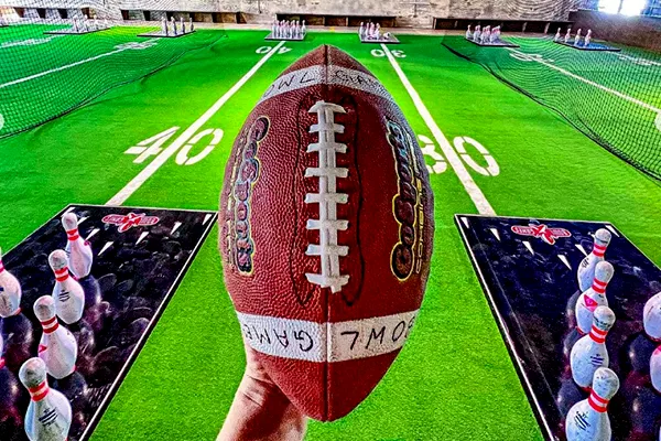 Unleash your inner champion! A football sits ready for action against the backdrop of Bowlgames' Pintoss field, where accuracy meets victory.